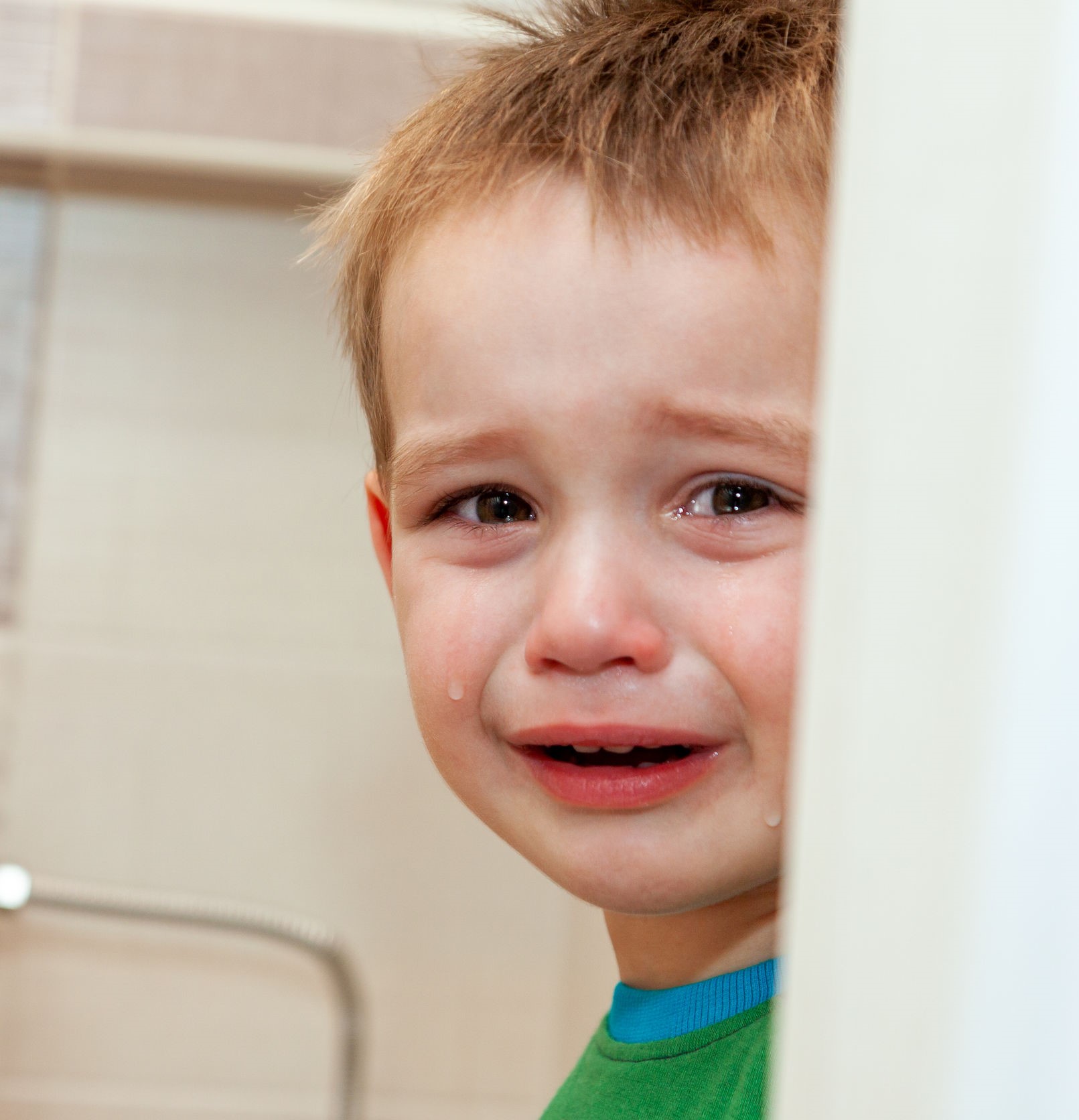 A crying child in a healthcare environment expressing distress.